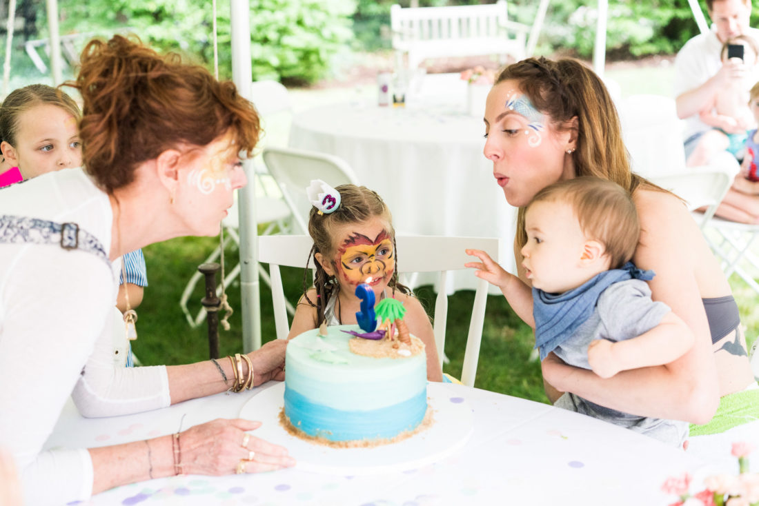 The whole family helps Marlowe Martino blow out the candles at her third birthday party