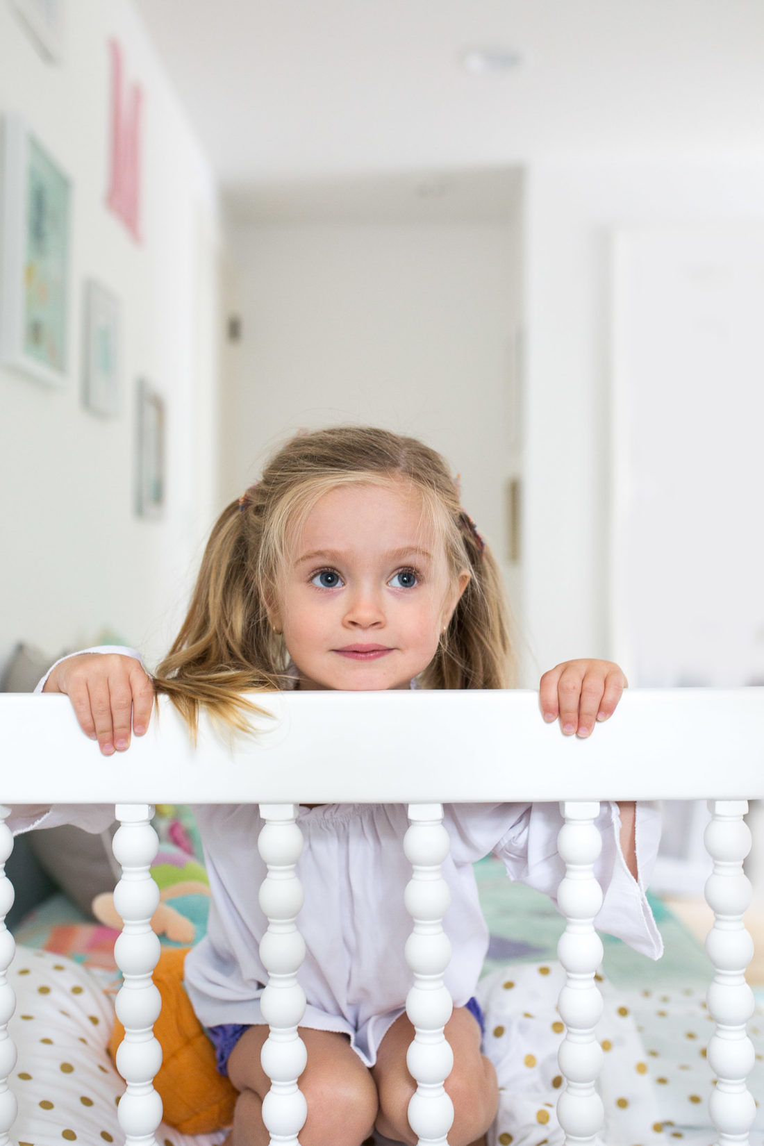 Marlowe Martino peeks over the edge of her Incy Interiors Big Girl bed