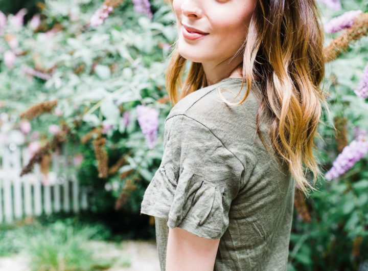 Eva Amurri Martino wears an army green flutter sleeve linen Tshirt in the courtyard of her Connecticut home