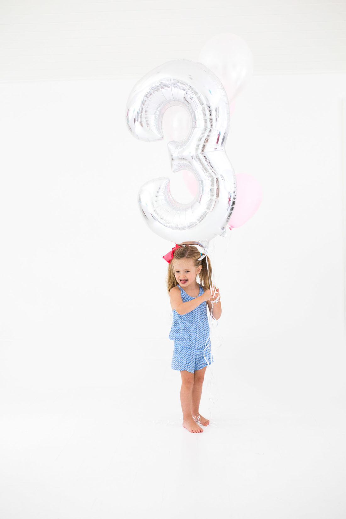 Marlowe Martino poses with a large balloon for her third birthday portraits