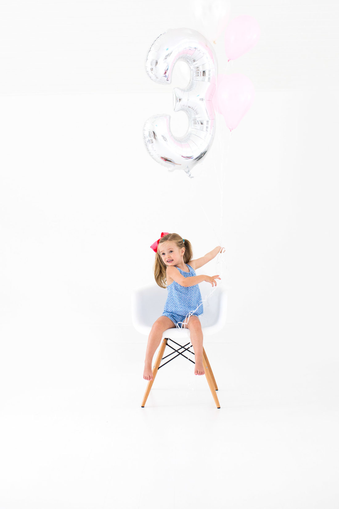 Marlowe Martino poses with a large balloon for her third birthday portraits