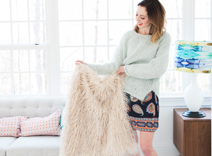 Eva Amurri Martino holds up a fuzzy shag throw blanket in her studio
