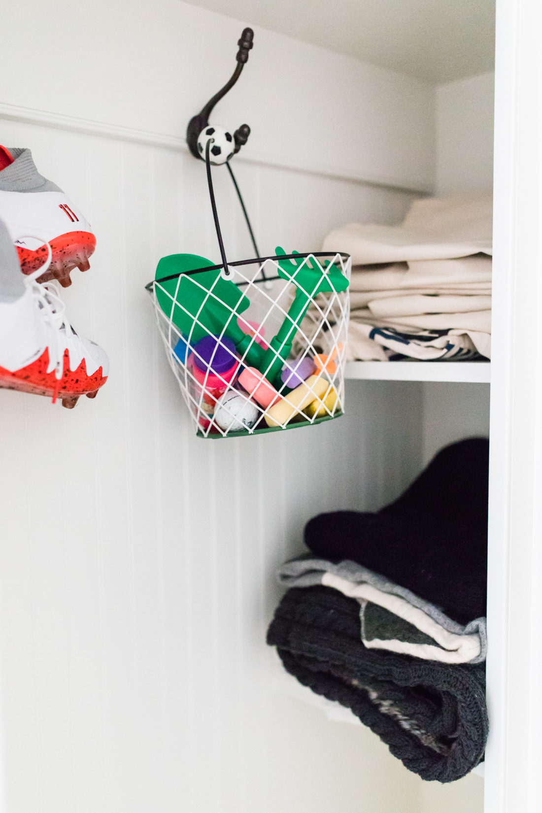 stacks of stroller blankets and canvas bags fill the cubbies next to buckets of kids' activities and Kyle Martino's soccer cleats in Eva Amurri Martino's Connecticut mud room