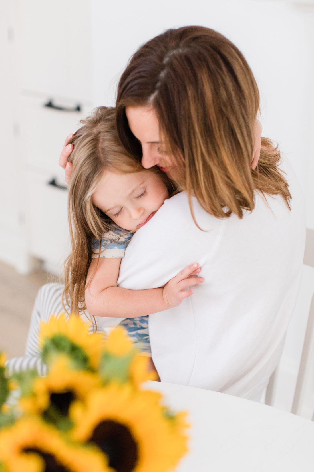 Eva Amurri Martino snuggles with daughter Marlowe at the kitchen table of her Connecticut home