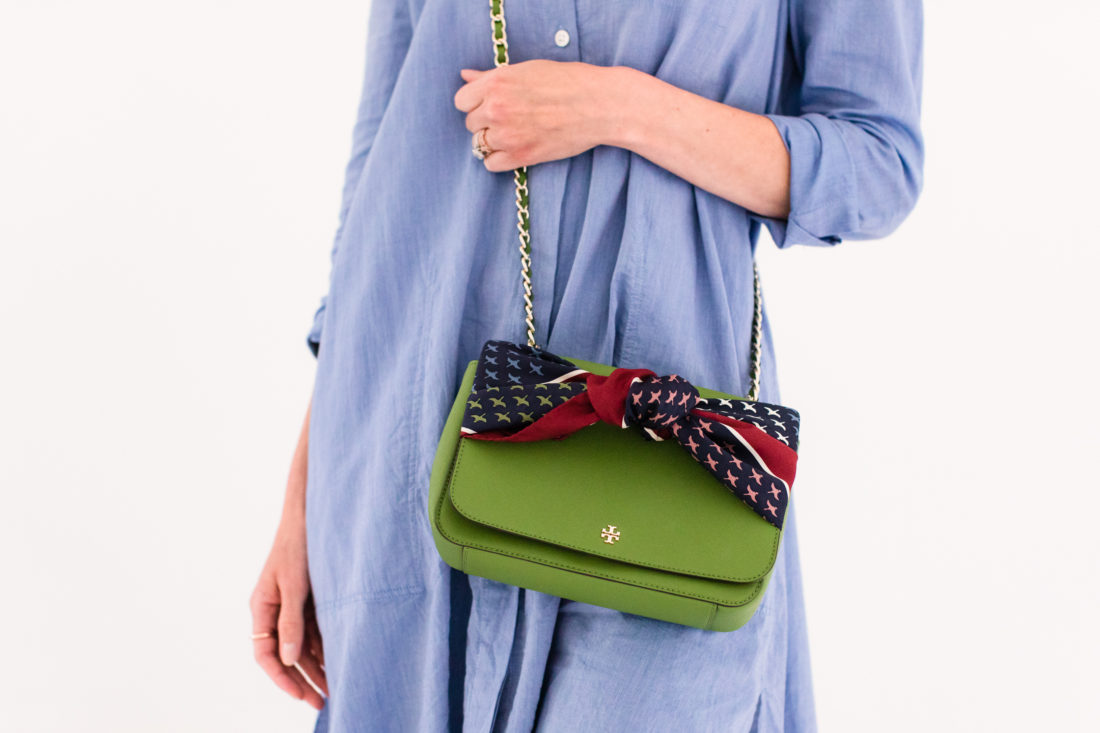 Eva Amurri Martino wears a blue shirt dress and styles a silk scarf to adorn her green tory burch bag