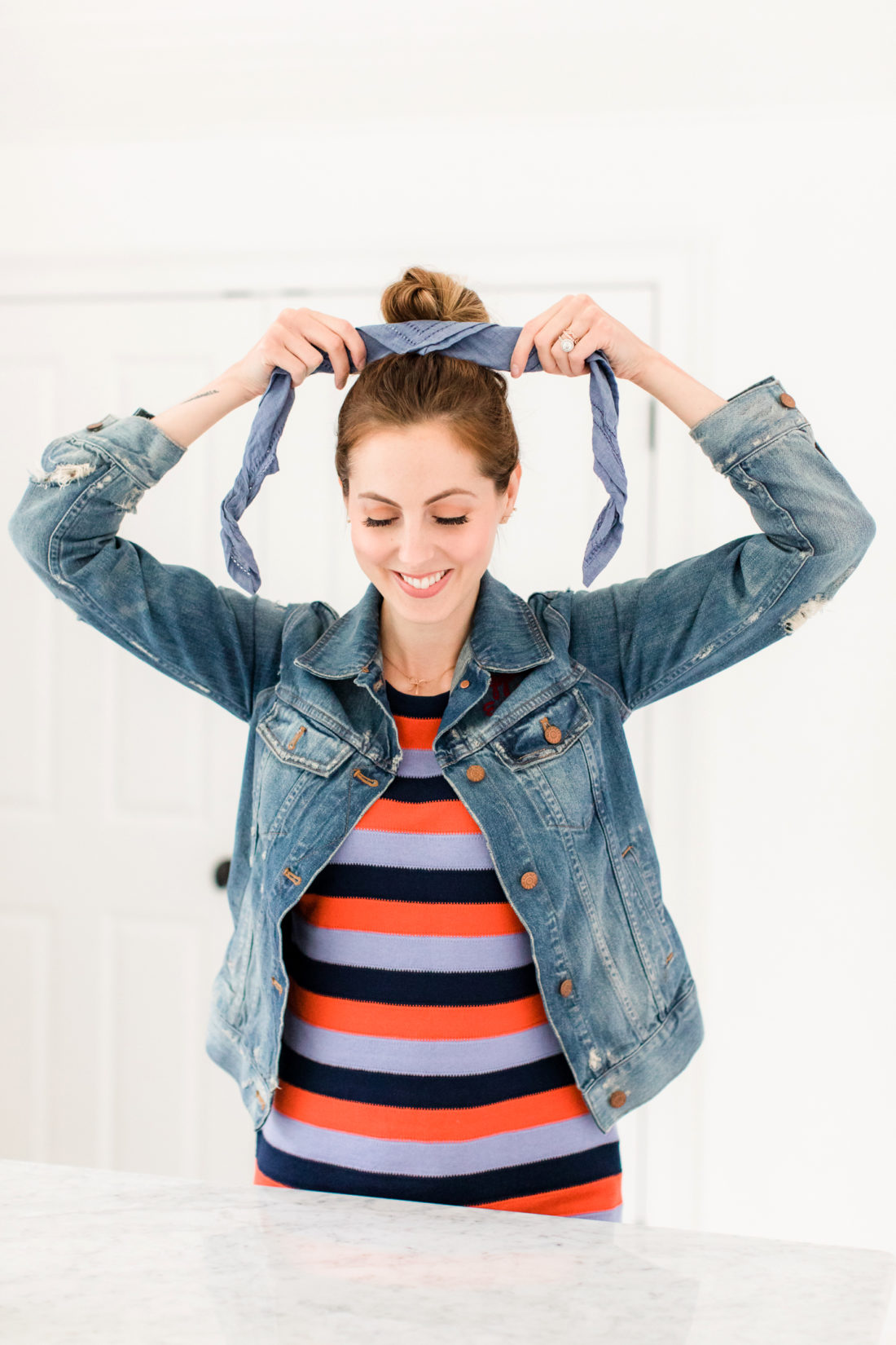 Eva Amurri Martino wears a striped dress and denim jacket, and wraps a linen kerchief around her bun to make a hairstyle