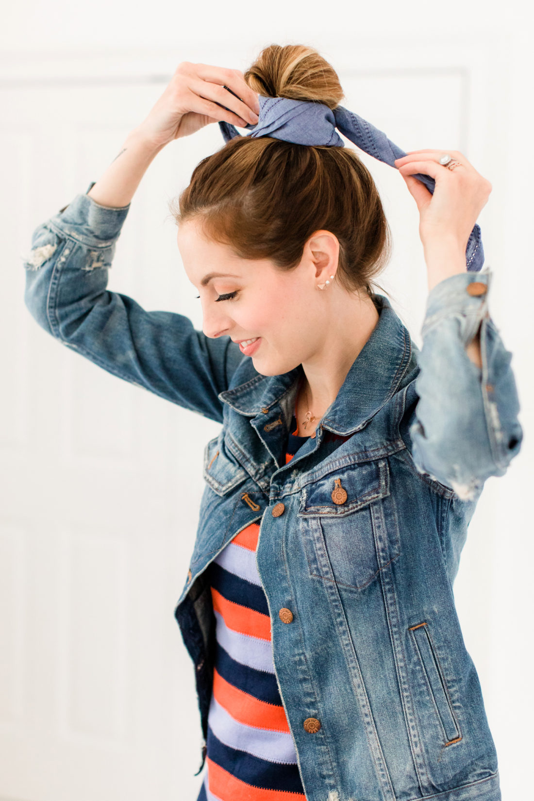 Eva Amurri Martino wears a striped dress and denim jacket, and wraps a linen kerchief around her bun to make a hairstyle