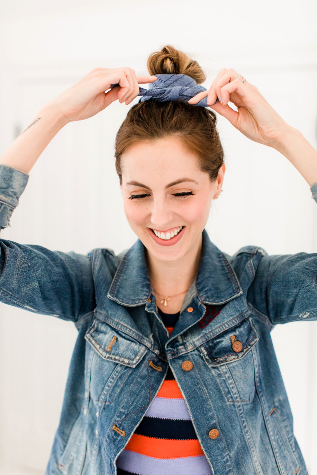 Eva Amurri Martino wears a striped dress and denim jacket, and wraps a linen kerchief around her bun to make a hairstyle