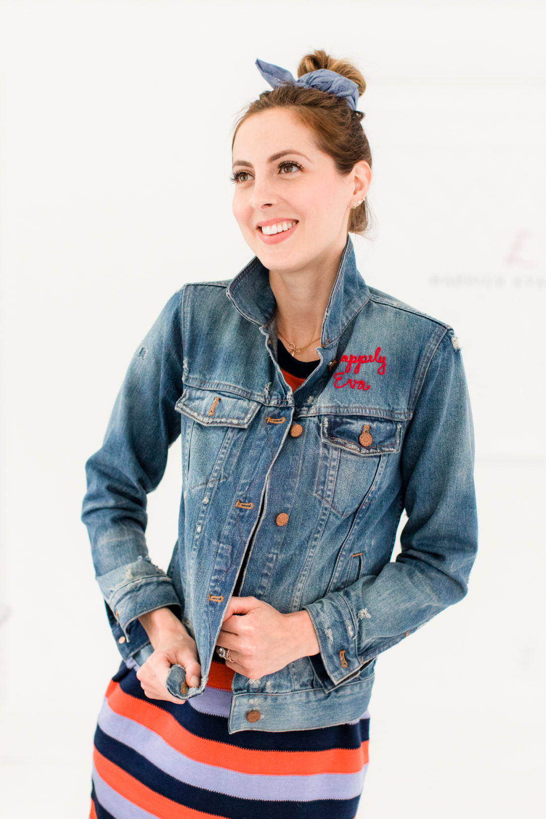 Eva Amurri Martino wears a striped dress and denim jacket and wears a simple kerchief bun in her hair