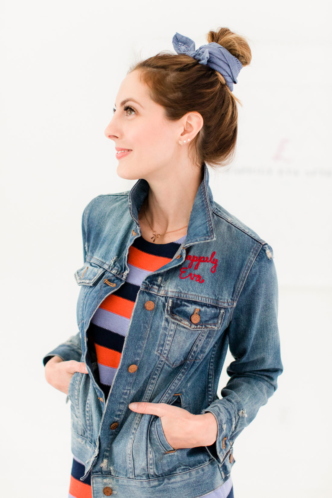 Eva Amurri Martino wears a striped dress and distressed denim jacket while rocking a kerchief bun hairstyle