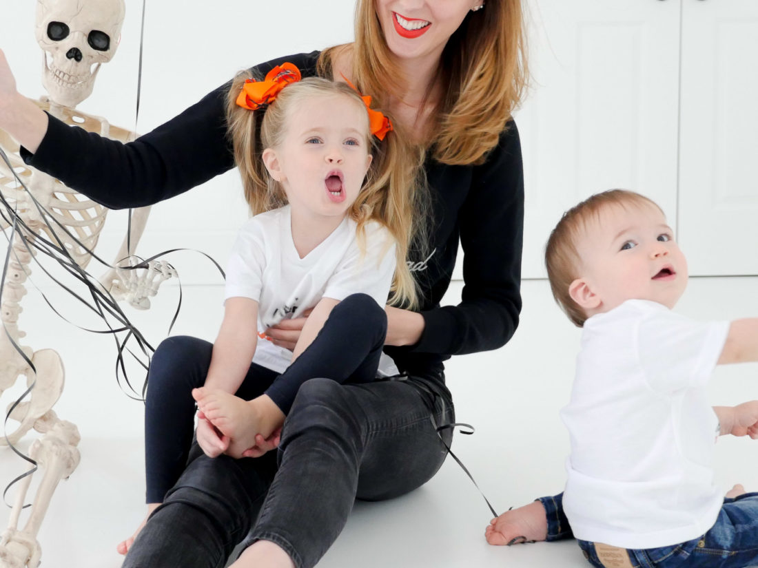 Eva Amurri Martino sits with children Marlowe and Major wearing custom Halloween themed tee shirts designed using The Happily App