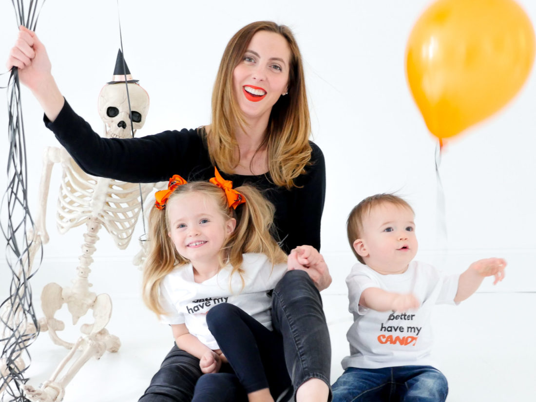 Eva Amurri Martino sits with children Marlowe and Major wearing custom Halloween themed tee shirts designed using The Happily App