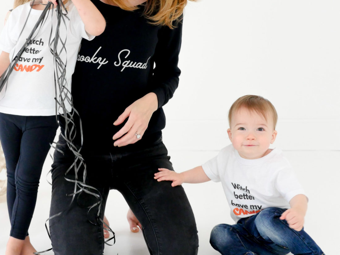 Eva Amurri Martino sits with children Marlowe and Major wearing custom Halloween themed tee shirts designed using The Happily App