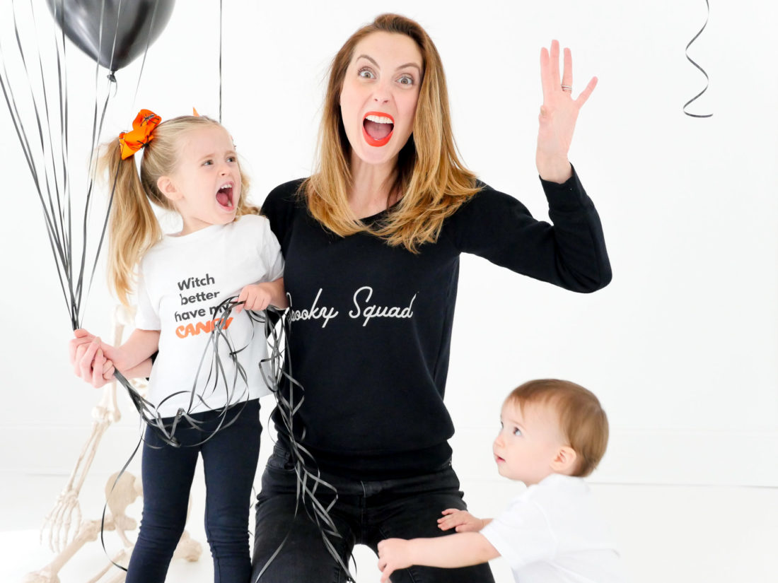 Eva Amurri Martino sits with children Marlowe and Major wearing custom Halloween themed tee shirts designed using The Happily App