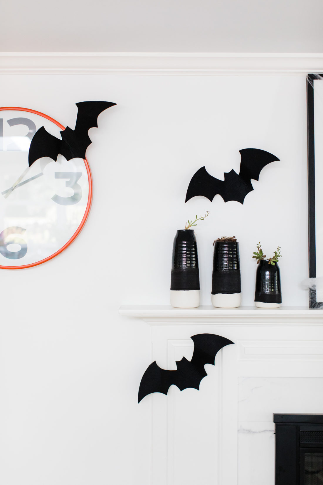 Felt bats fly around an orange clock in Eva Amurri Martino's Halloween decorated kitchen