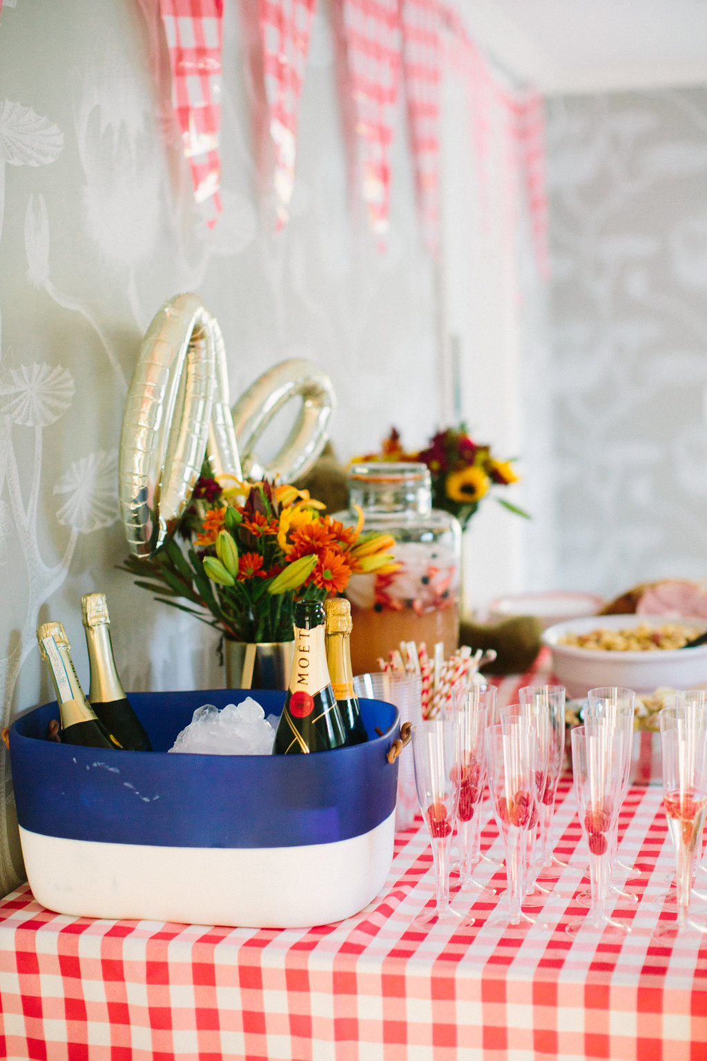 The cocktail setup on the red and white checked buffet for Major Martino's first birthday party with a TEddy bear picnic theme