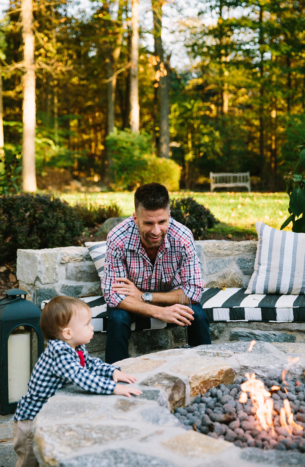 Kyle and Major Martino sit out by the fire pit at their connecticut home for Major's first birthday party