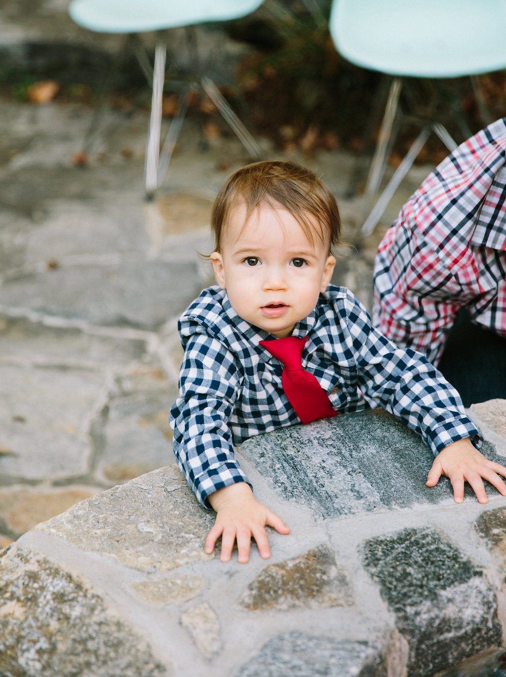 Kyle and Major Martino sit out by the fire pit at their connecticut home for Major's first birthday party