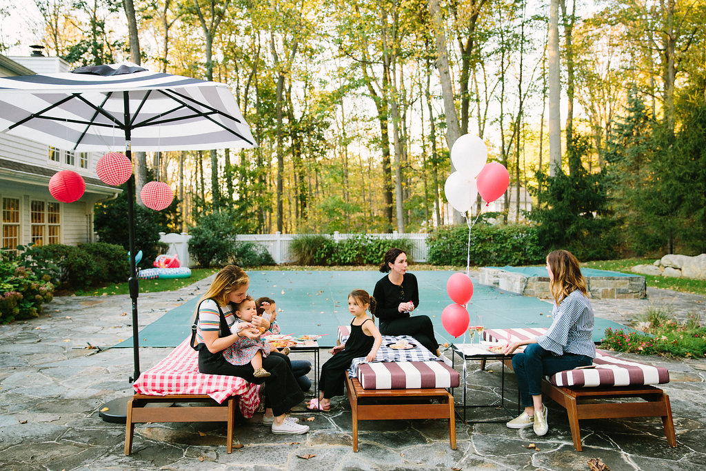 Guests sit outside in Eva Amurri Martino's backyard for Major Martino's first birthday party