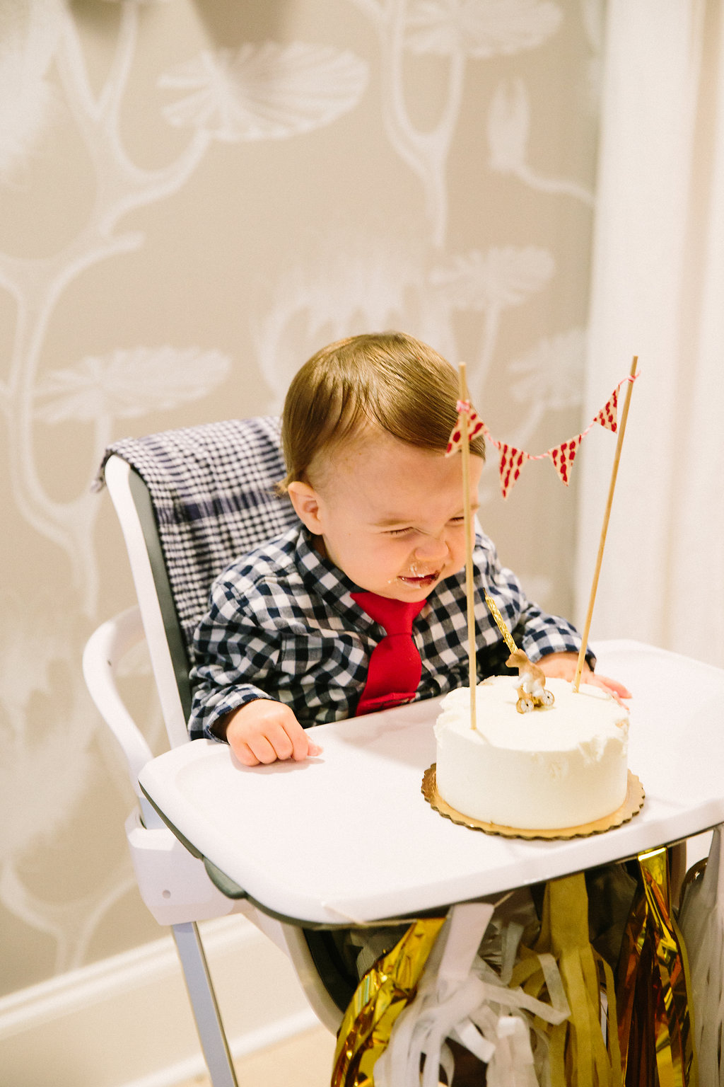 Major laughs as he sits in front of his first birthday cake
