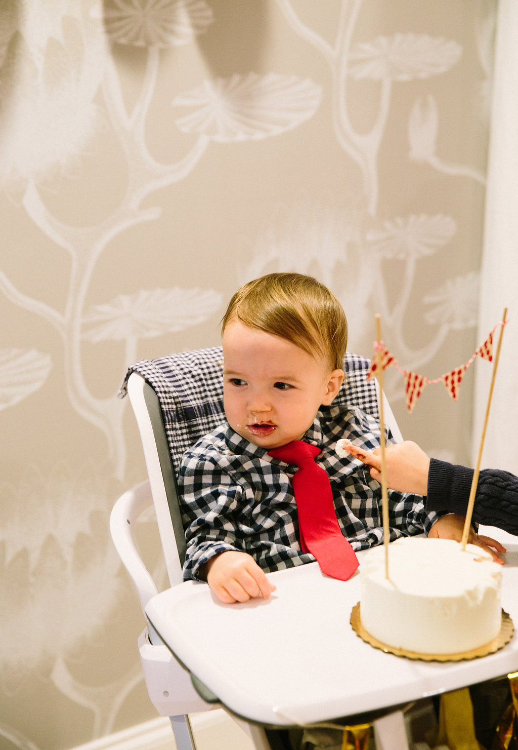 Major Martino eats his first taste of cake during his first birthday party