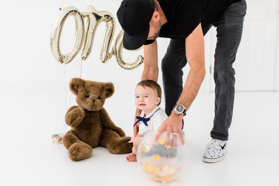 Kyle Martino helps his son Major sit for his first birthday portraits