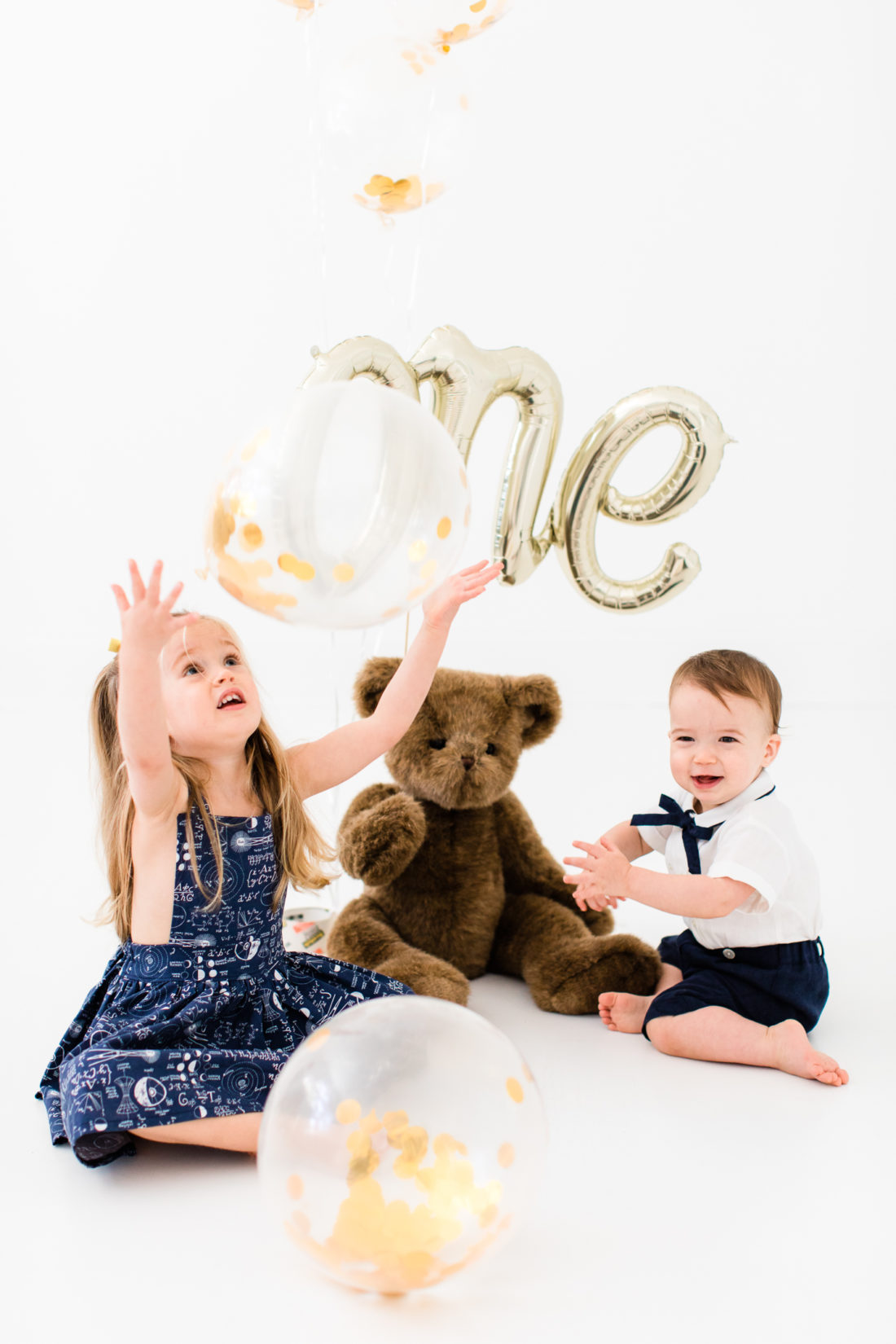 Marlowe and Major Martino play with balloons during the portraits for Major's first birthday