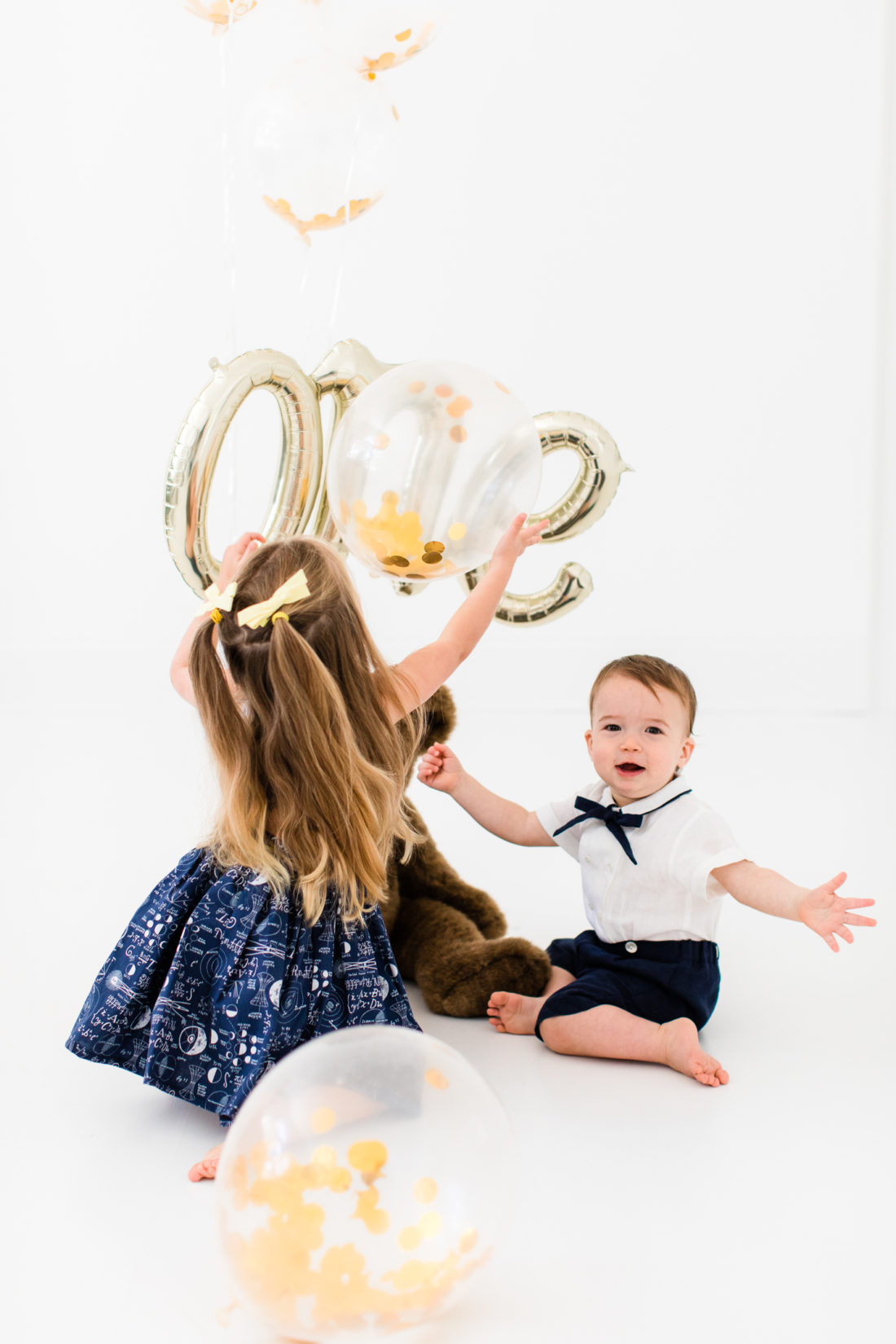 Marlowe and Major Martino play with balloons during the portraits for Major's first birthday