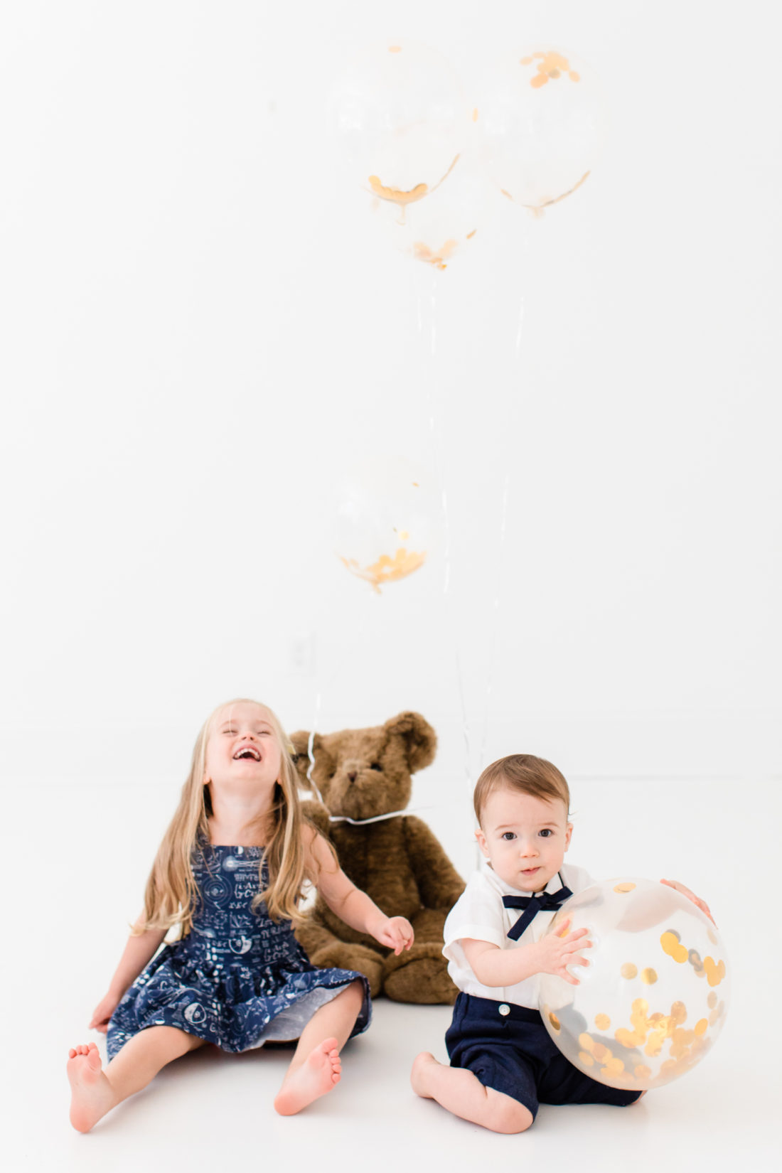 Marlowe and Major Martino play with balloons during the portraits for Major's first birthday