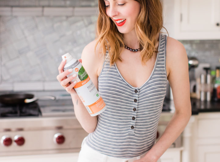Eva Amurri Martino wears a striped bodysuit and white jeans and cleans her connecticut kitchen with seventh generation spray
