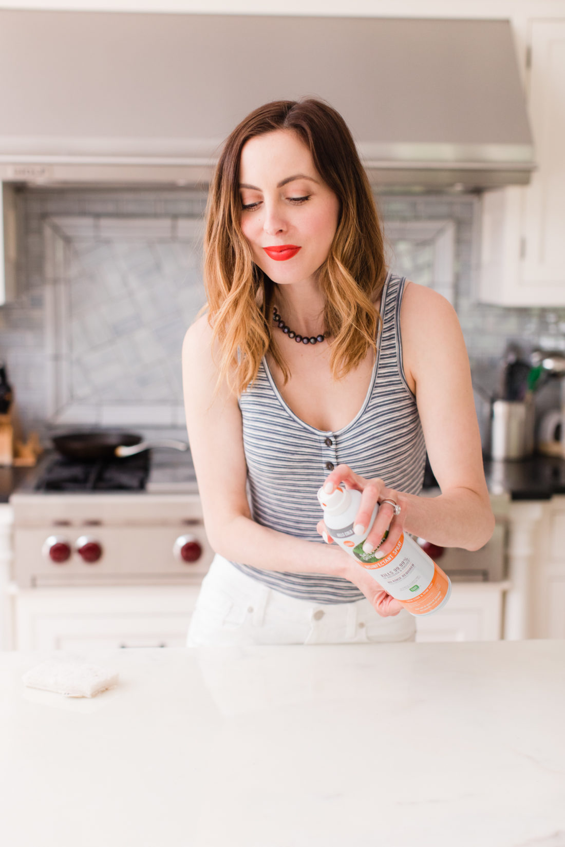 Eva Amurri Martino sprays the countertops with Seventh Generation disinfecting spray in the kitchen of her connecticut home