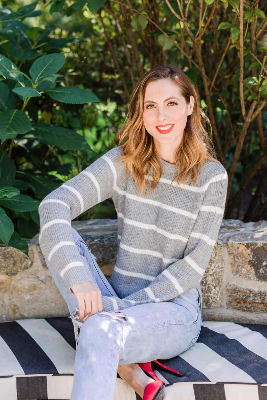 Eva Amurri Martino wears a striped sweater and red heels out by her fire pit in Connecticut