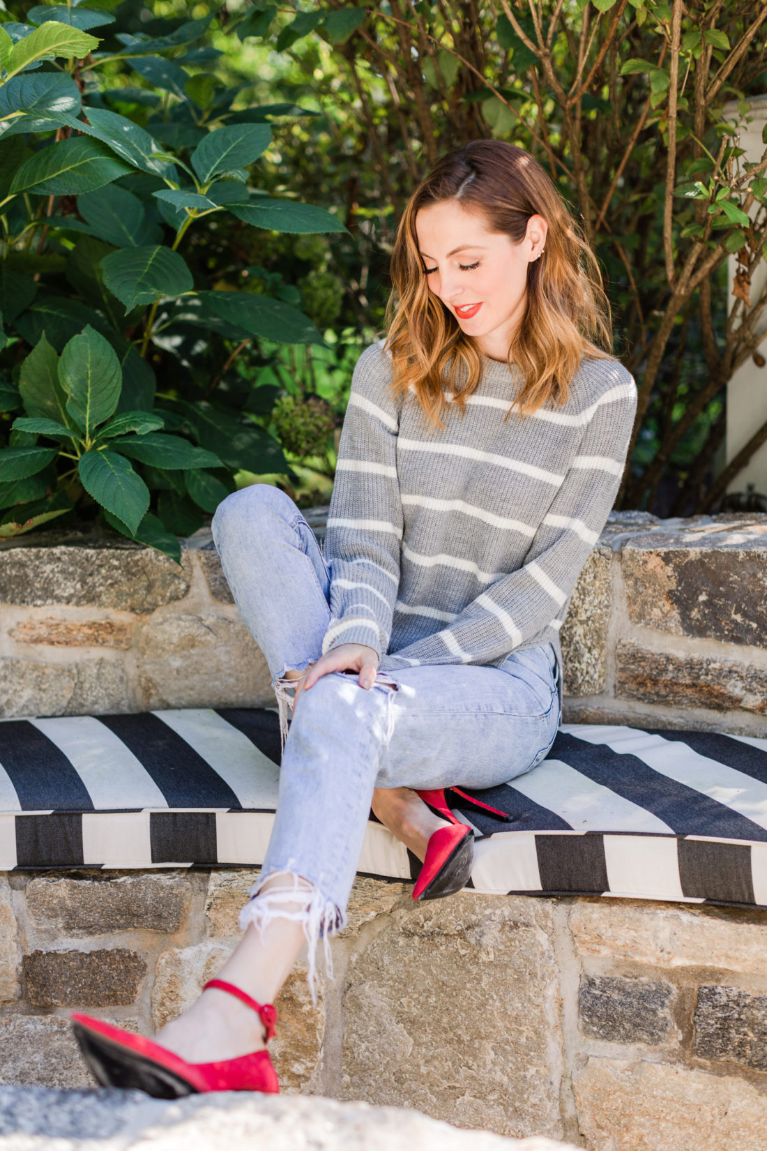 Eva Amurri Martino wears a striped sweater and red heels out by her fire pit in Connecticut