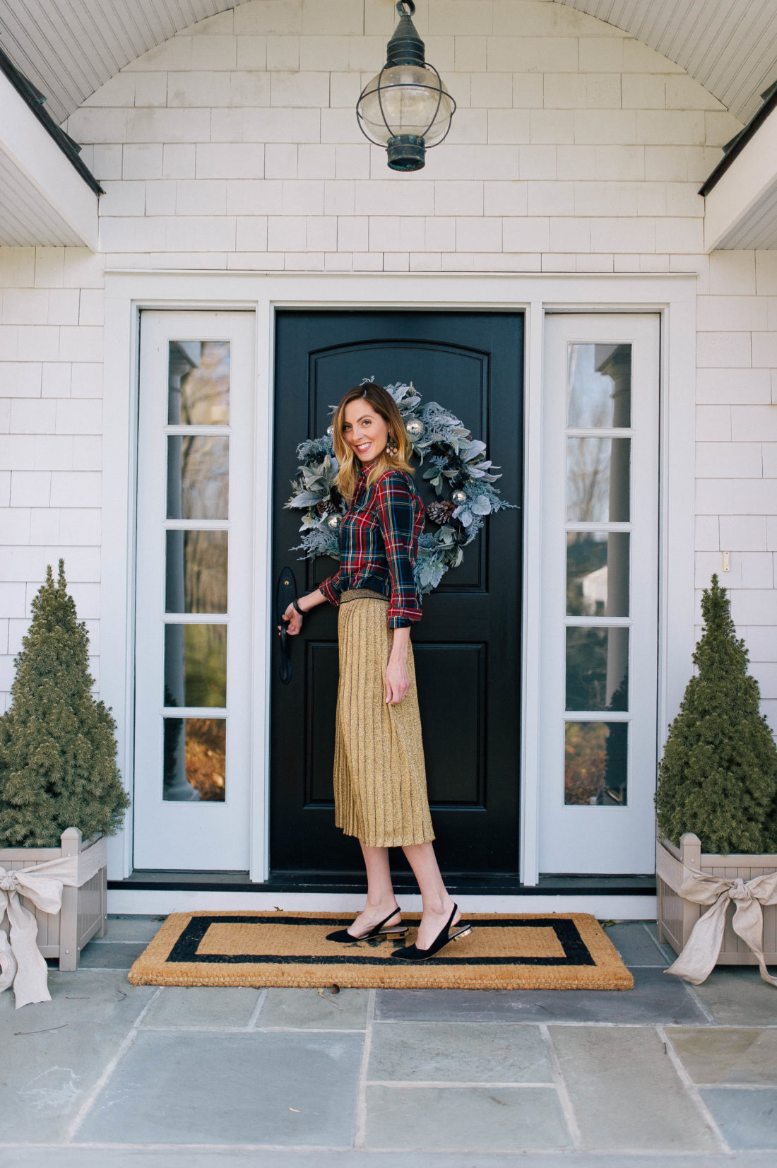 Eva Amurri Martino stands at the doorway of her Connecticut home which is decorated for the holidays