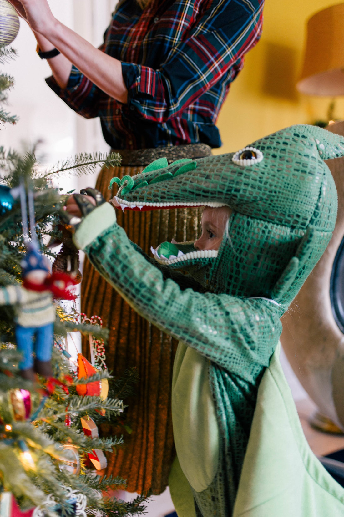 Marlowe Martino dresses up in a dragon costume and decorates the christmas tree