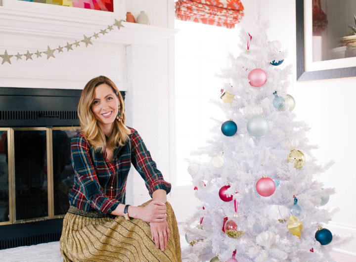 Eva Amurri Martino sits next to her white christmas tree decorated with colorful ornaments in the family room of her Connecticut home