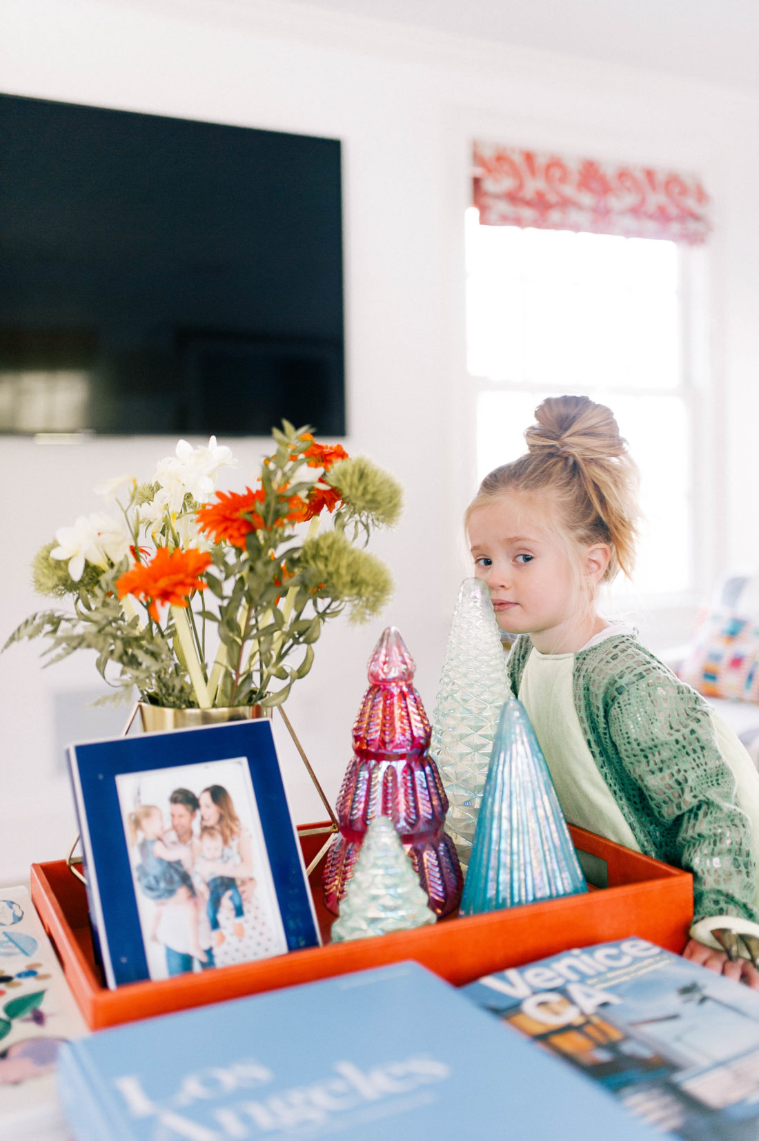 Marlowe Martino stands next to the coffee table that has been decorated for the christmas holiday