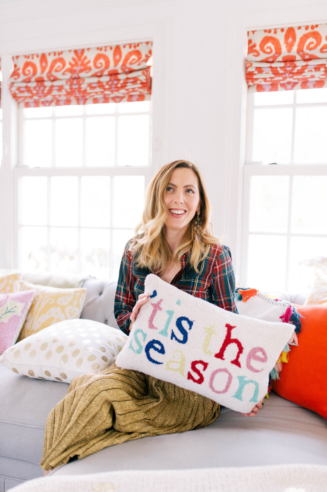 Eva Amurri Martino holds a "'tis the season" pillow on the couch of her Connecticut home