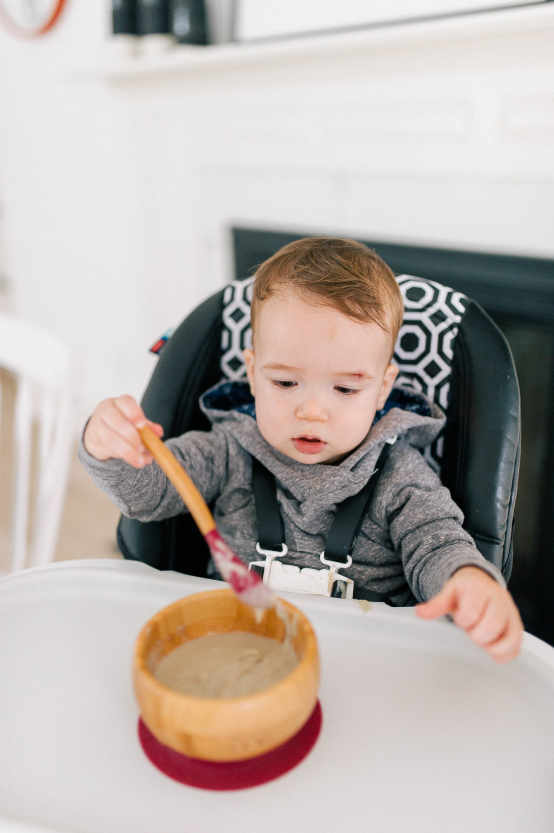 Major Martino eats porridge in his high chair that has SpoonfulOne mixed in to it