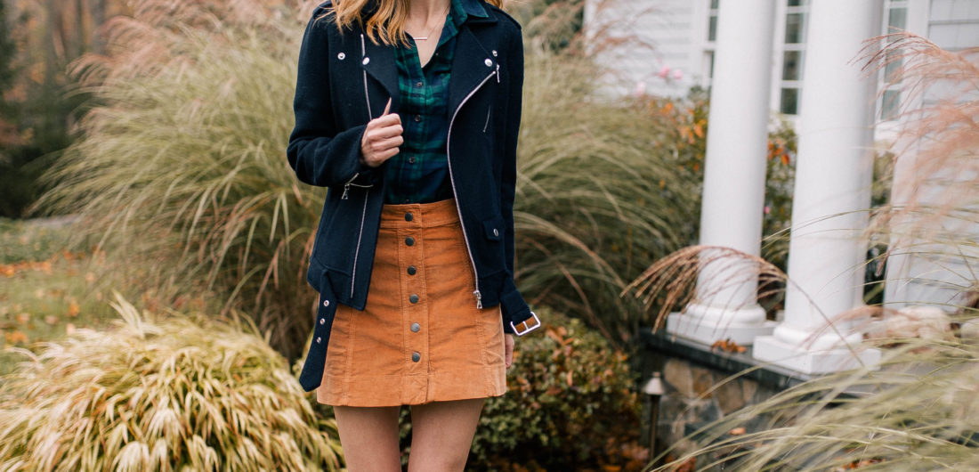 Eva Amurri Martino wears a plaid top, navy blue jacket, corduroy skirt, and black booties and walks down the pathway to her Connecticut home