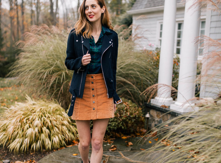 Eva Amurri Martino wears a plaid top, navy blue jacket, corduroy skirt, and black booties and walks down the pathway to her Connecticut home