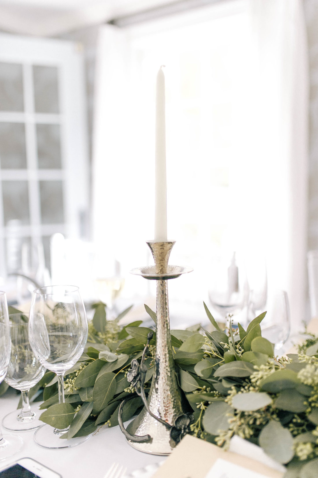 Silver candlesticks amidst the foliage at the Friendsgiving at Eva Amurri Martino's Connecticut home