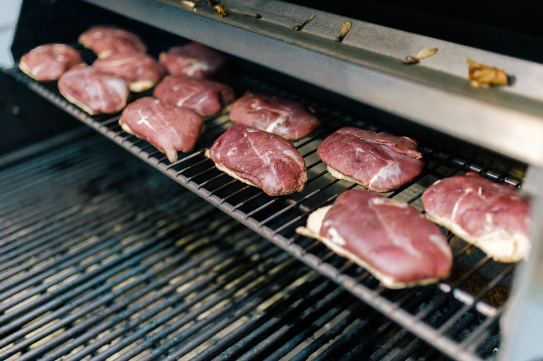 Duck breasts cook on the grill at Eva Amurri Martino's Friendsgiving