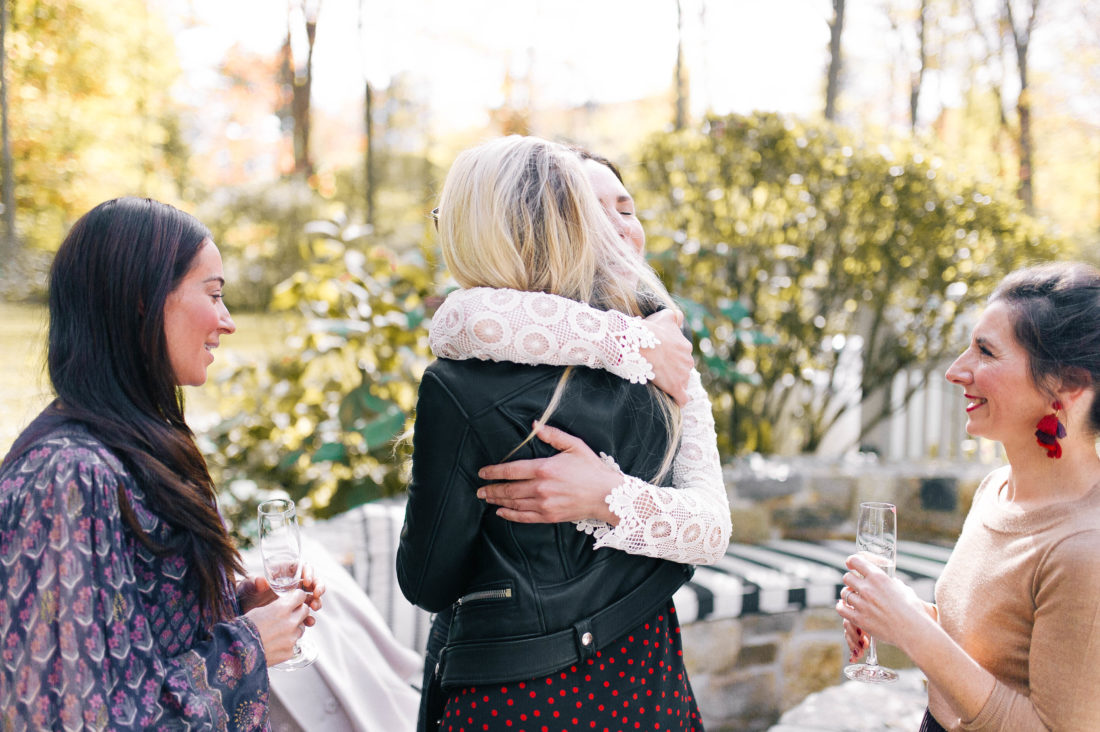 ladies hug at Eva Amurri Martino's Friendsgiving benefitting No Kid Hungry