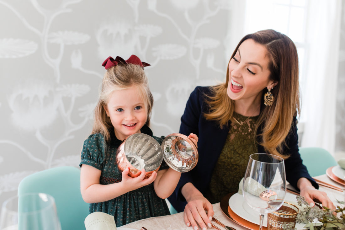 Marlowe Martino shows the inside of a copper pumpkin at the Thanksgiving table in her Connecticut home