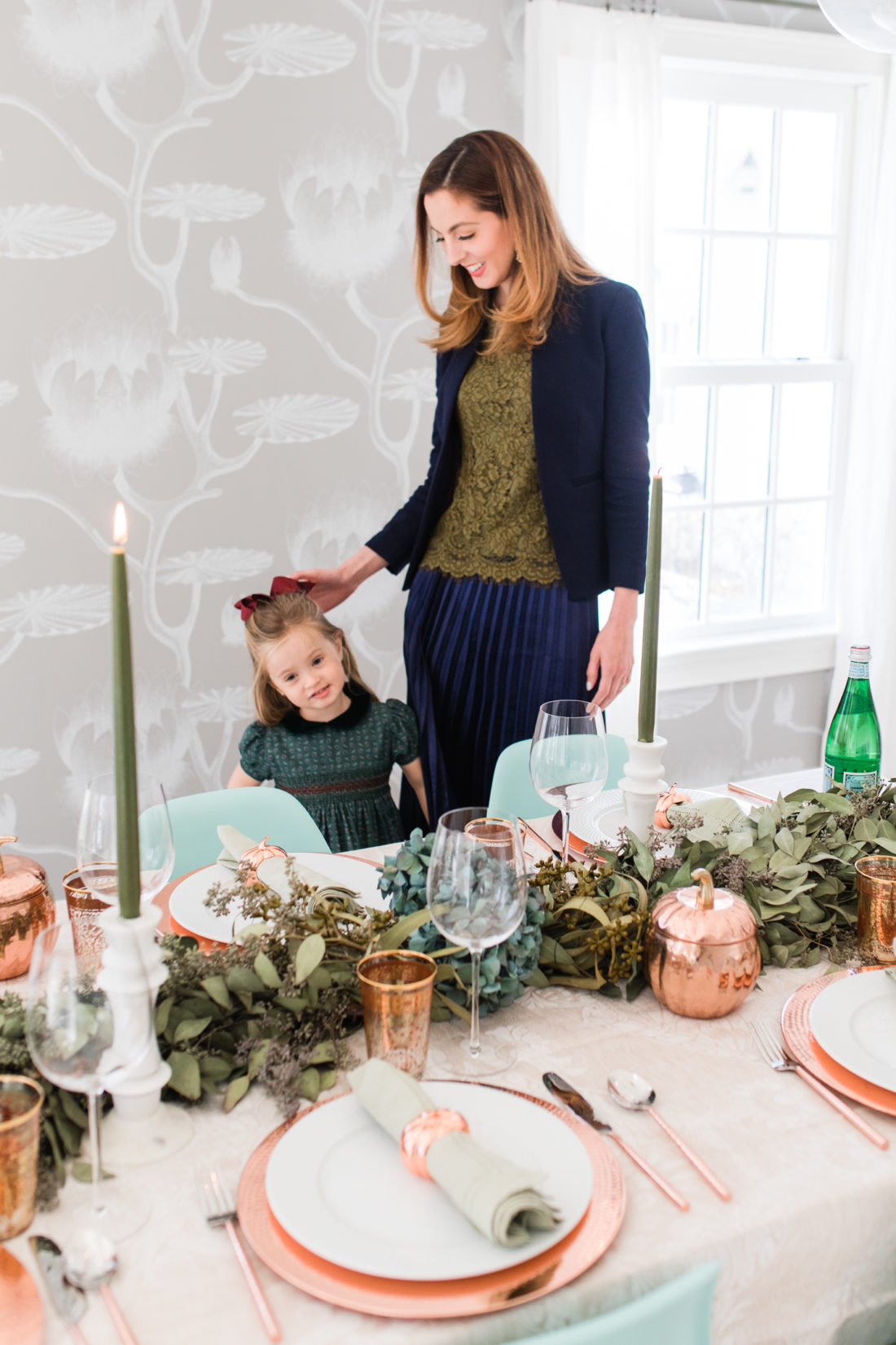 Marlowe Martino helps her Mom set the Thanksgiving table wearing a green velvet smocked party dress