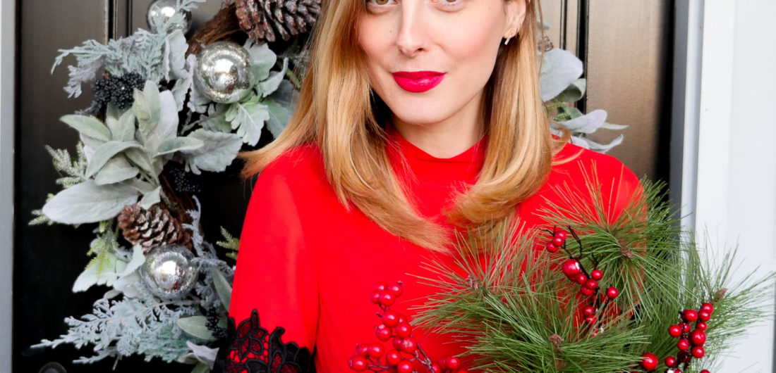 Eva Amurri Martino wears a festive red dress with black lace detailing for a holiday party