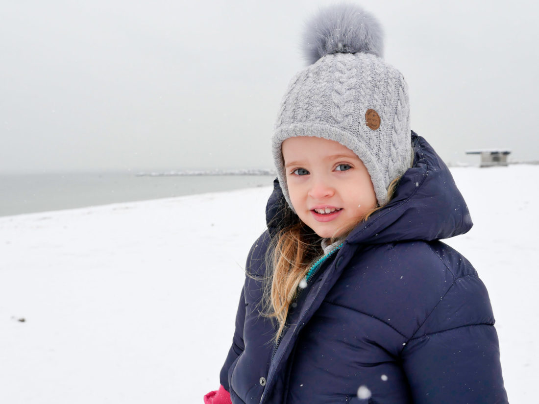 Marlowe Martino stands on the beach in the snow in Westport CT