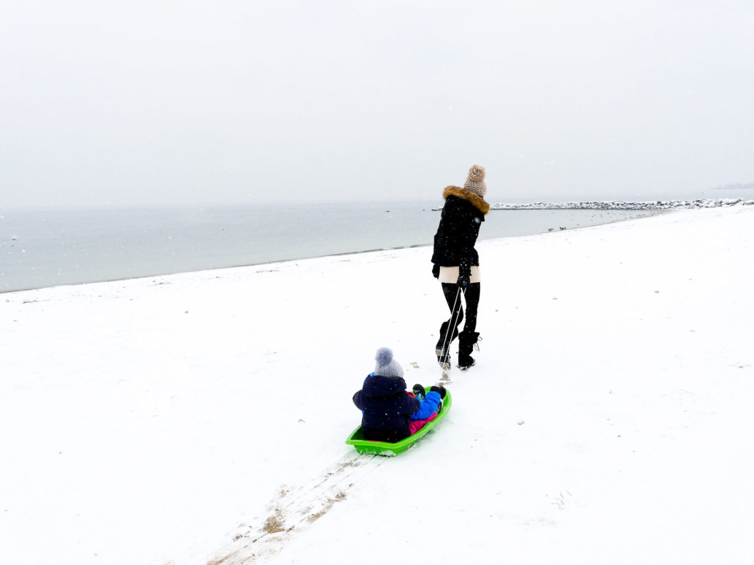 Eva Amurri Martino pulls her children through the snow on the beach in Westport, CT