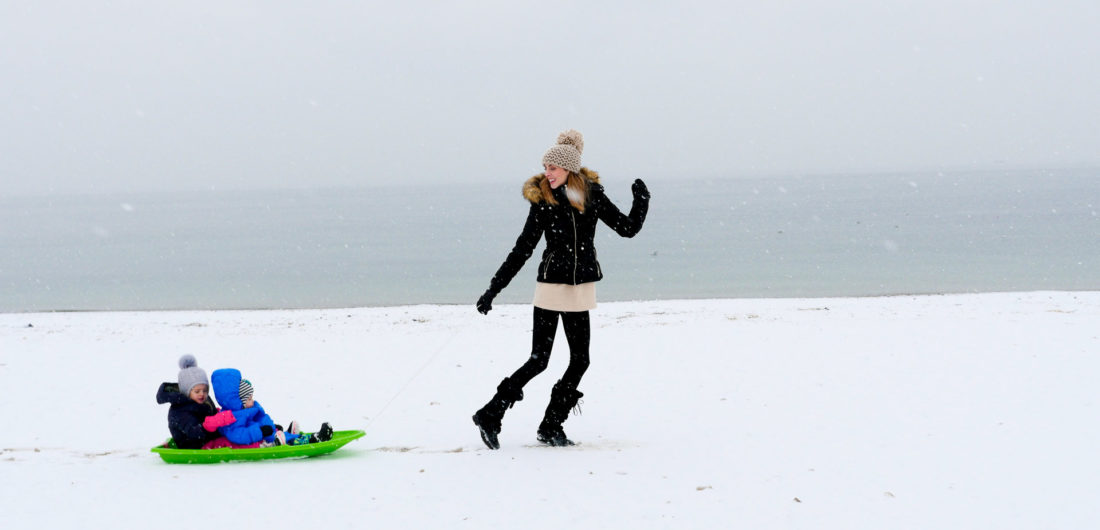 Eva Amurri Martino pulls her children through the snow on the beach in Westport, CT